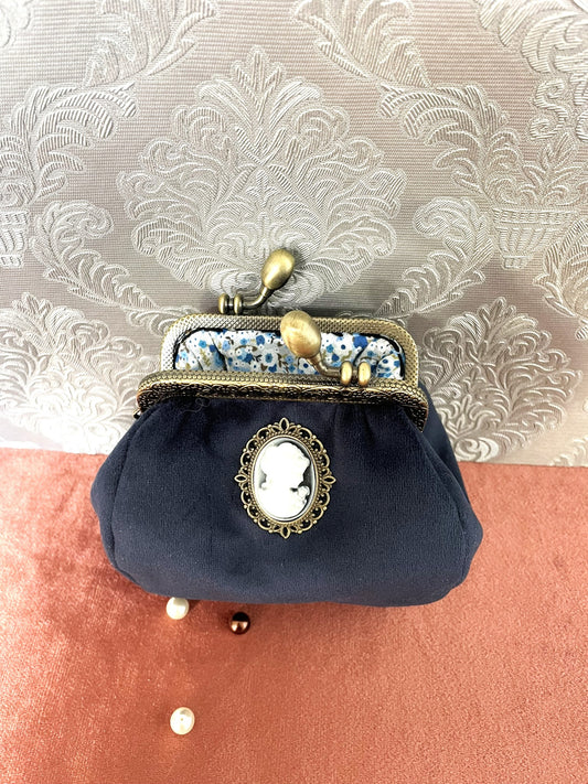 Vue de l'intérieur du porte-monnaie avec une doublure en tissu fleuri bleu et blanc.