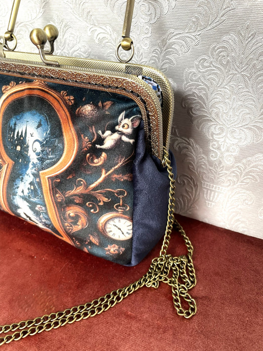 Intérieur de la pochette avec doublure à fleurs bleues et fermoir bronze antique.