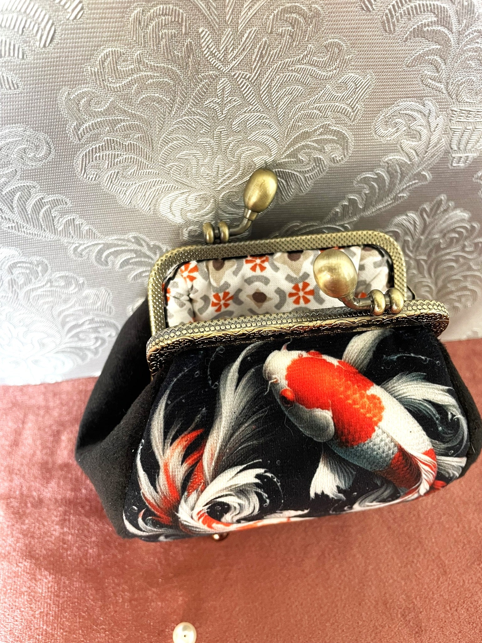 Vue intérieure du porte-monnaie avec sa doublure en coton beige aux fleurs orange et motifs gris