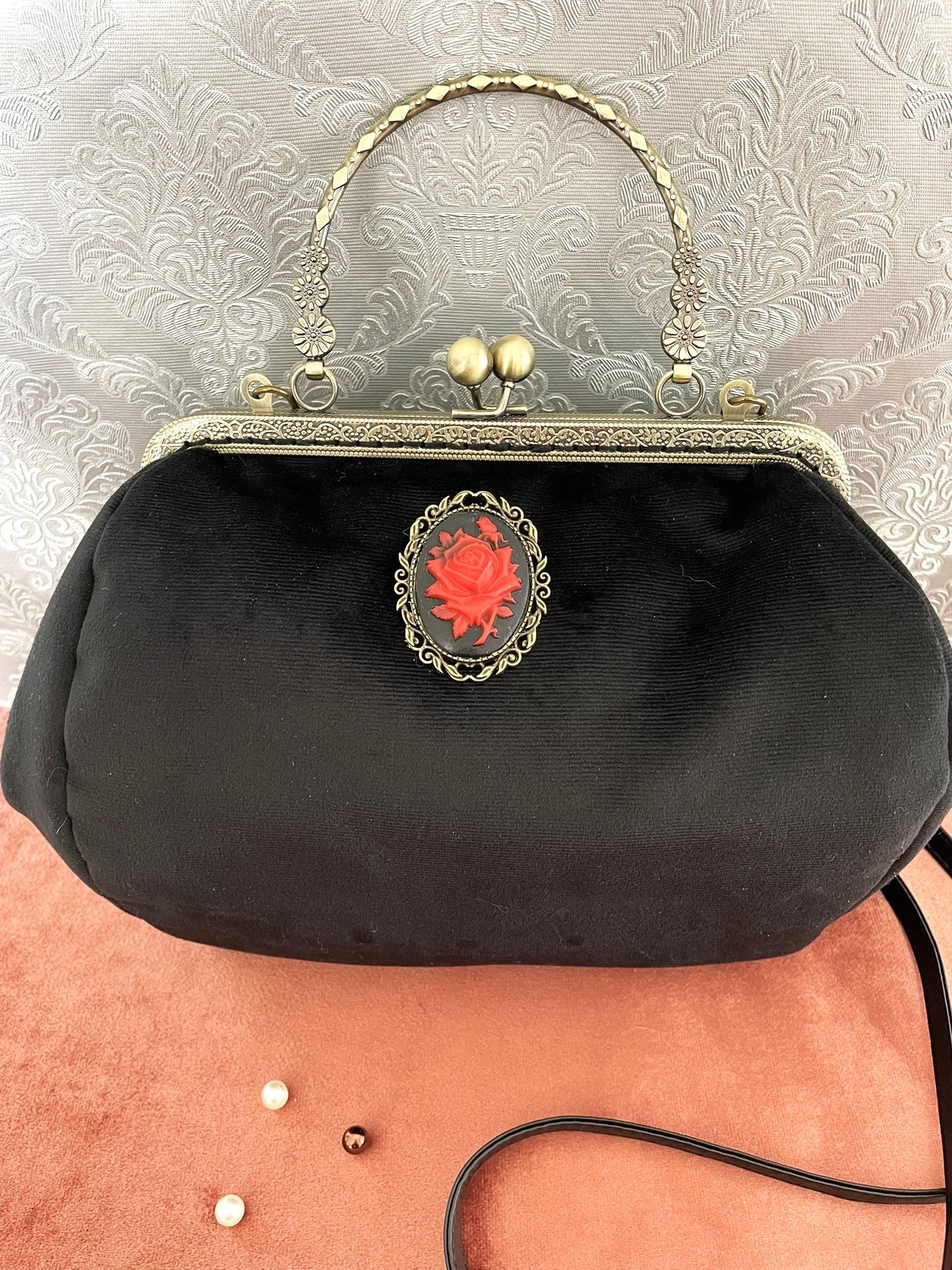 Sac à main gothique romantique en velours noir avec un grand camée orné d'une rose rouge.
