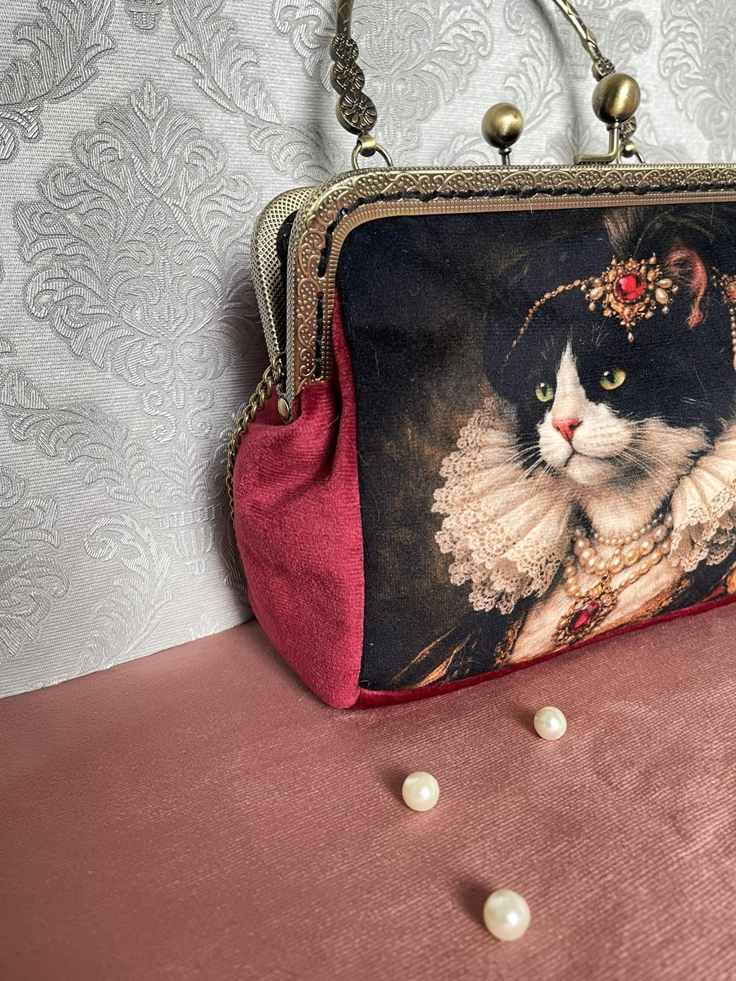 Détail du soufflet latéral en velours bordeaux et fermoir esprit rétro en métal  sur le sac chat de style victorien Le Comptoir de Suzanne.